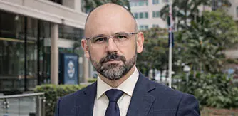 Portrait of the Queensland Minister for Energy in a professional setting.